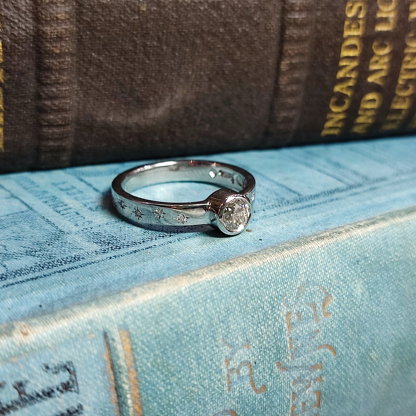 Platinum Rubover Engagement Ring with 0.40ct Diamond and Star Set Shoulders