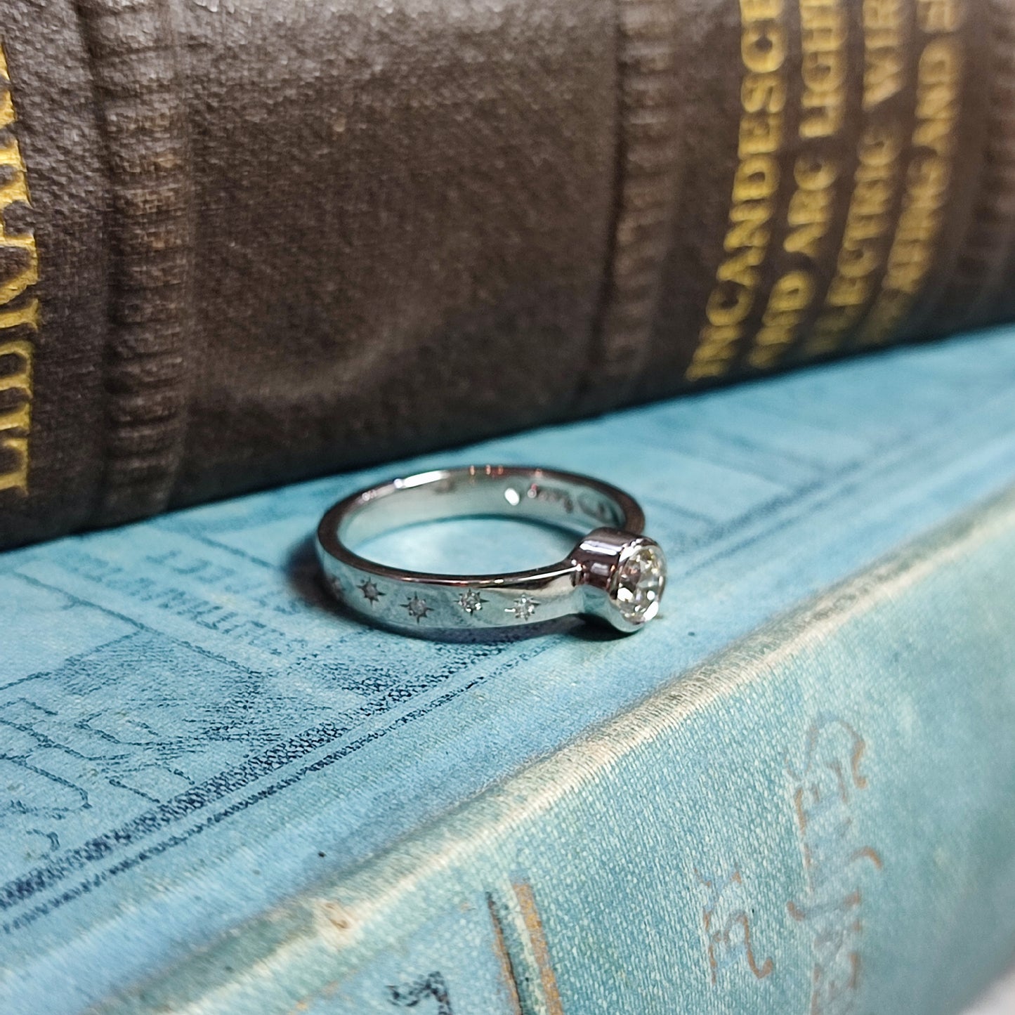 Platinum Rubover Engagement Ring with 0.40ct Diamond and Star Set Shoulders