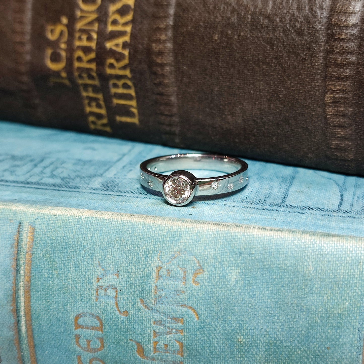 Platinum Rubover Engagement Ring with 0.40ct Diamond and Star Set Shoulders