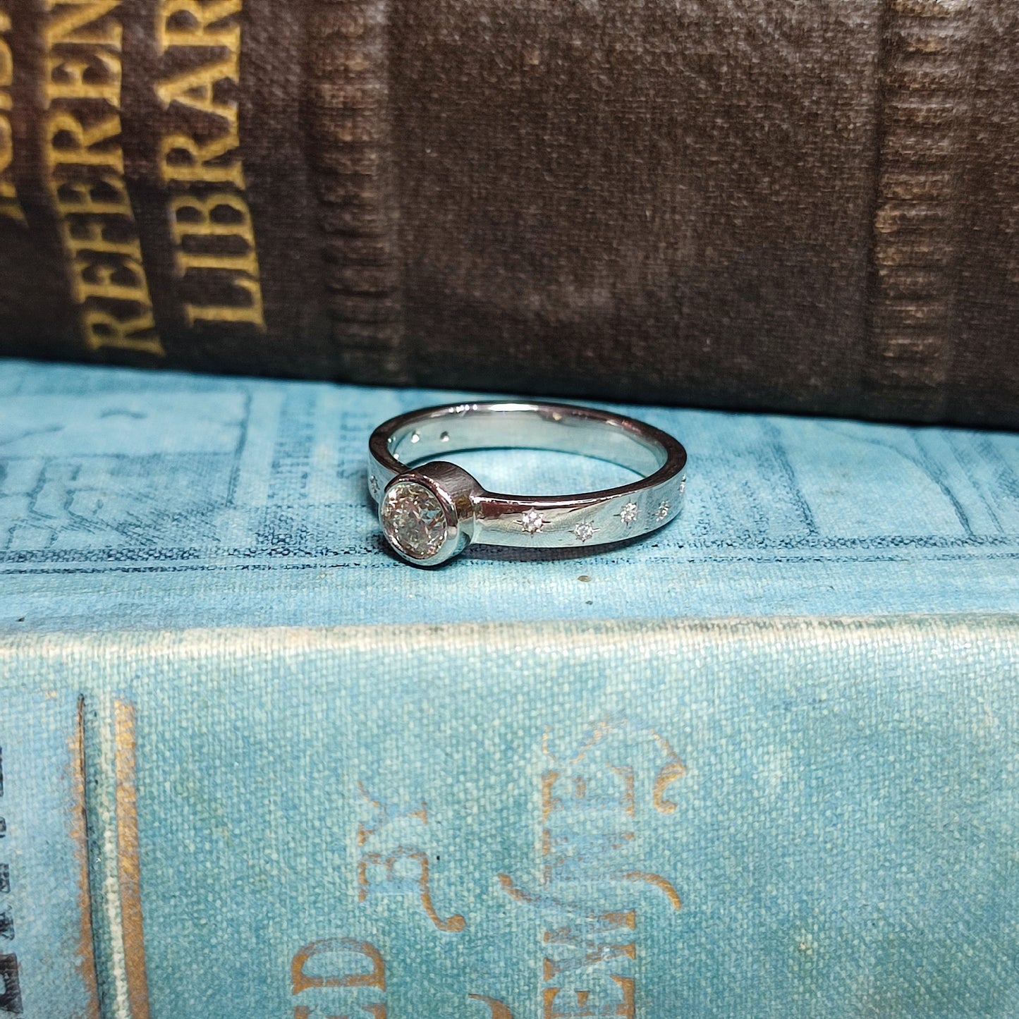 Platinum Rubover Engagement Ring with 0.40ct Diamond and Star Set Shoulders