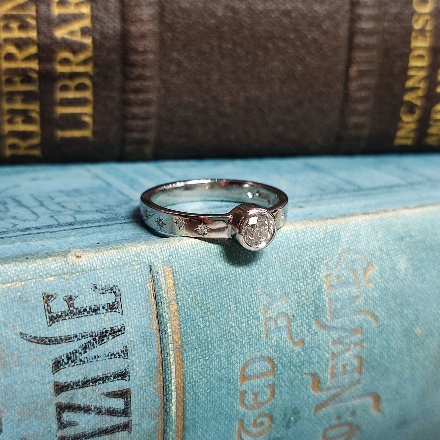 Platinum Rubover Engagement Ring with 0.40ct Diamond and Star Set Shoulders