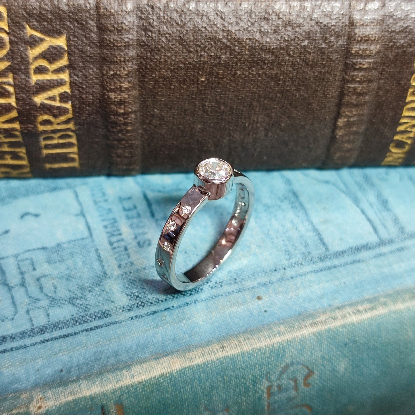 Platinum Rubover Engagement Ring with 0.40ct Diamond and Star Set Shoulders