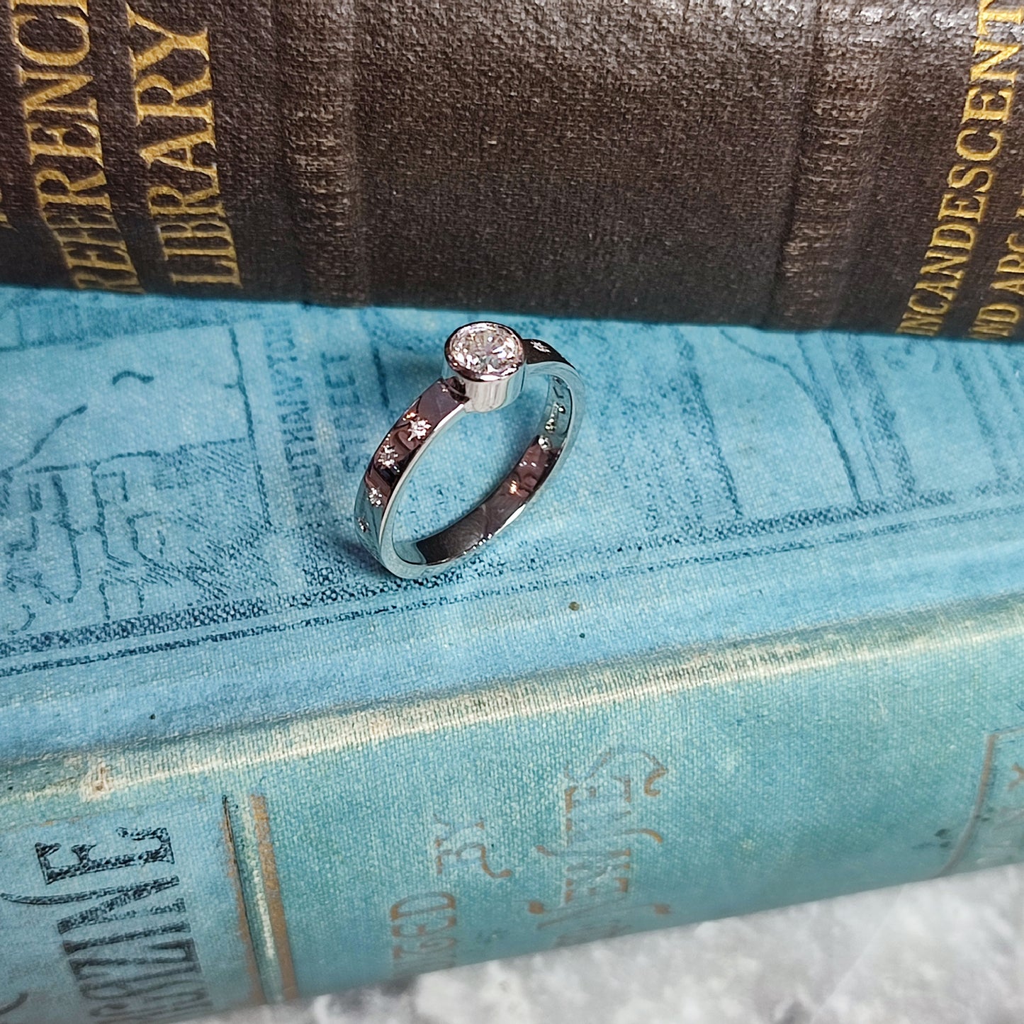 Platinum Rubover Engagement Ring with 0.40ct Diamond and Star Set Shoulders