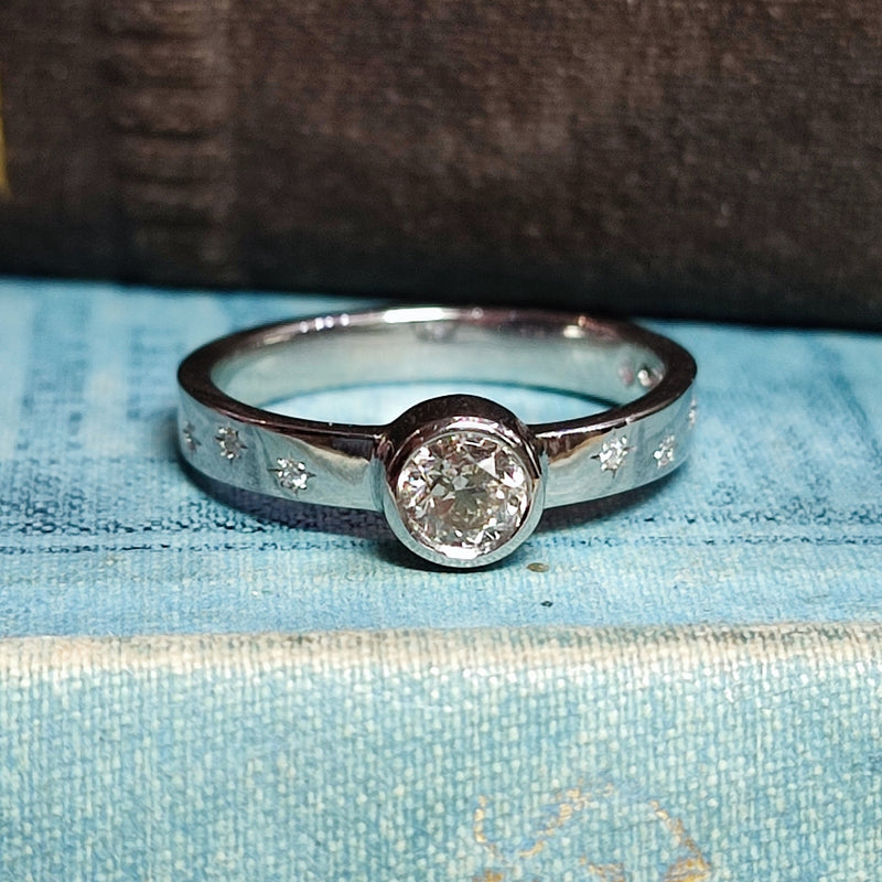 Platinum Rubover Engagement Ring with 0.40ct Diamond and Star Set Shoulders